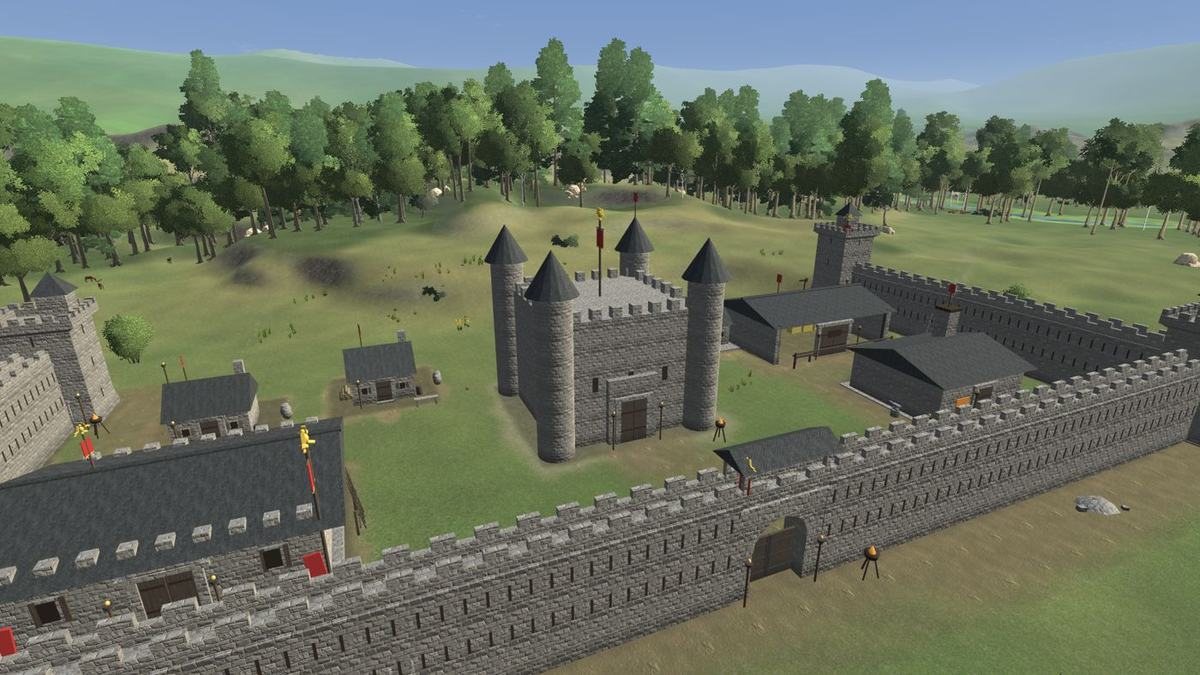 A stone keep with round towers behind a long stone wall